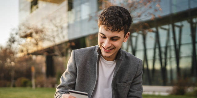 adult man use mobile phone and credit card for online shopping outdoor