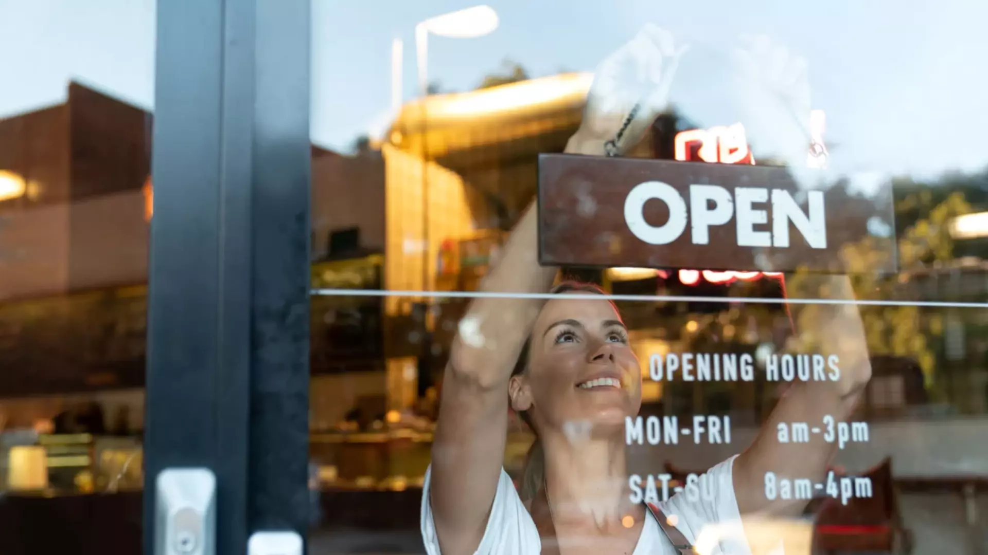 Business owner hanging sign.webp