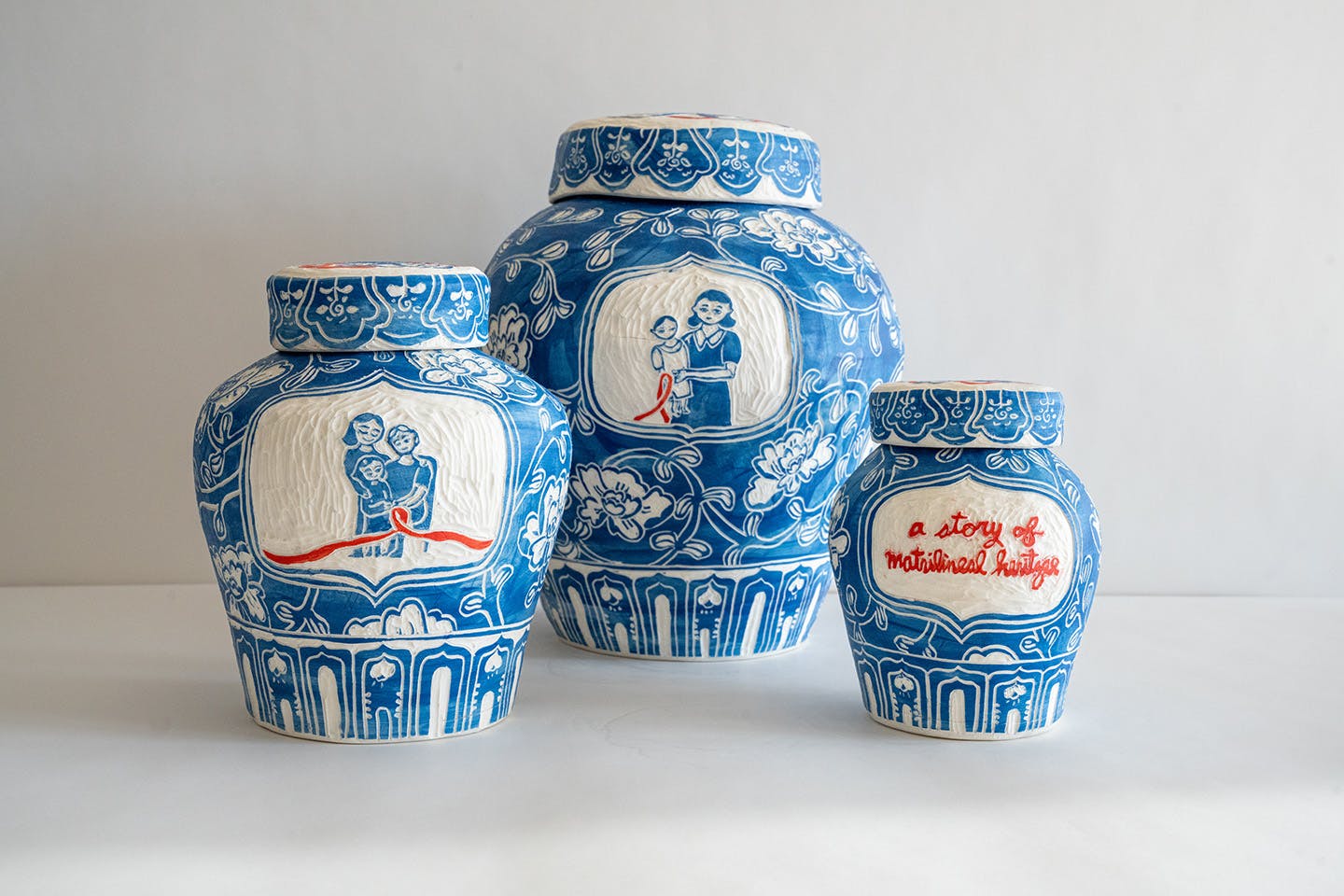 A still photograph of three ceramic vessels, each differing in size.