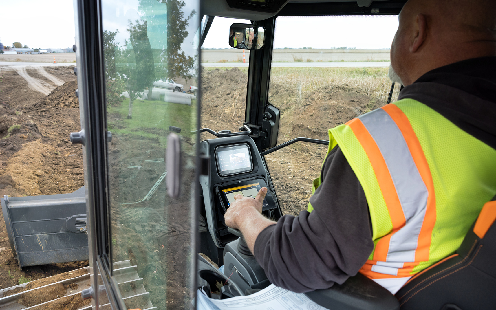 A heavy equipment operator sits in the cab of a DEVELON DD100 dozer.