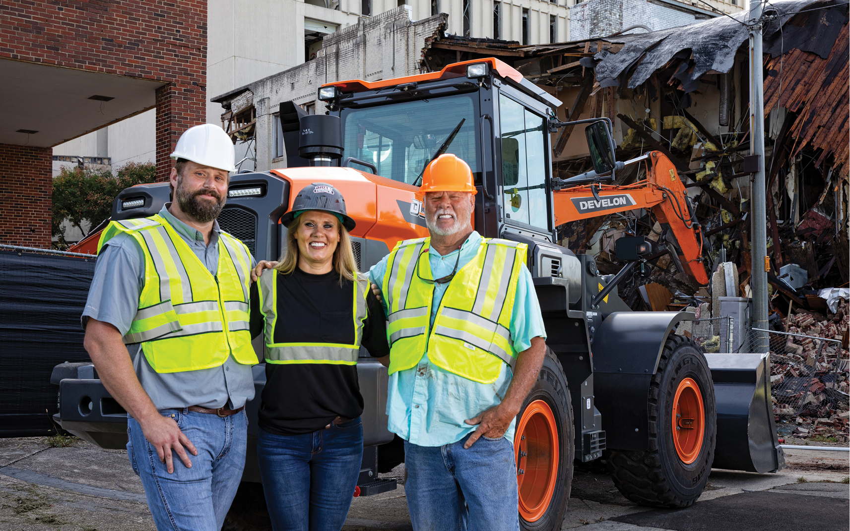 Wesley, Melissa and Tommy Britt of Britt Demolition and Recycling Inc. next to the company’s DEVELON wheel loader.