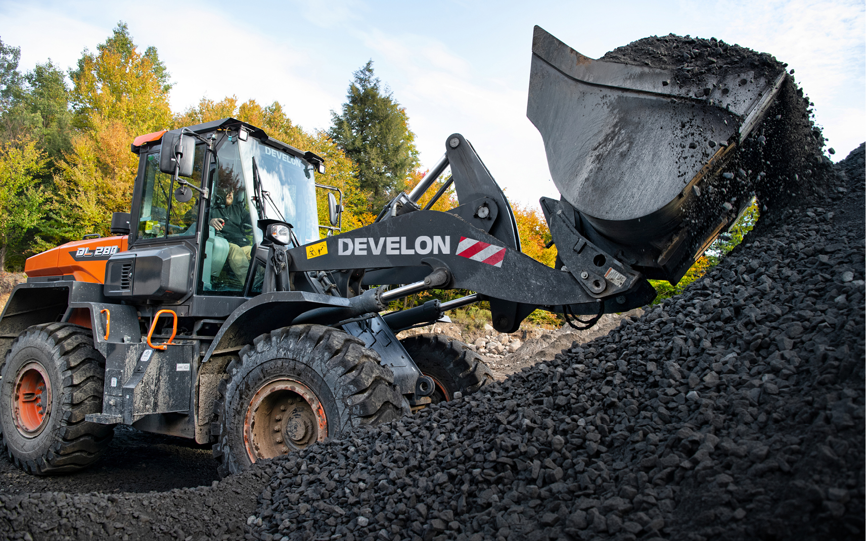 DEVELON DL280-7 wheel loader lifting dirt.