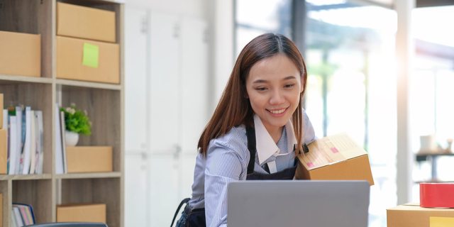 SME entrepreneur Business Young Asian freelance girl works with a laptop and box at home, about eCommerce, business, seller, Asian, employee, entrepreneur, box, merchant, Online SME business ideas,