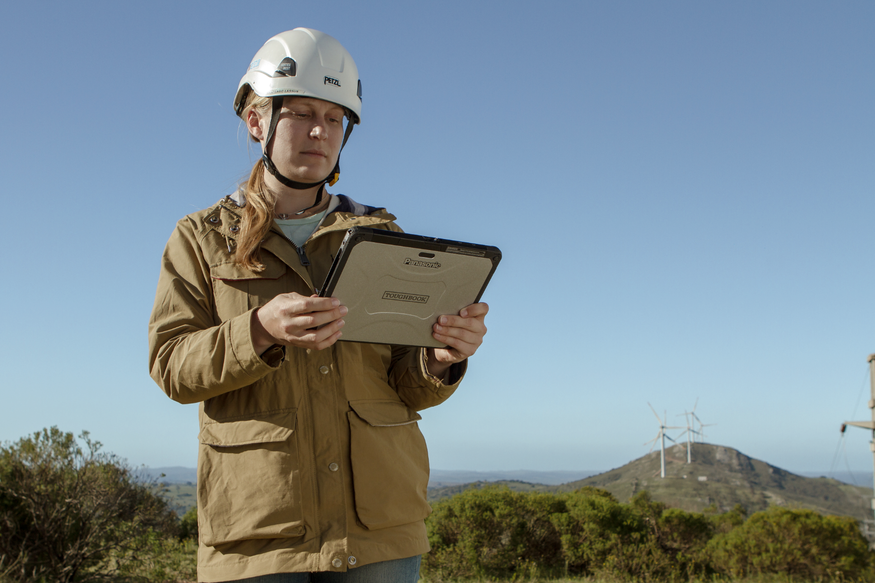 A field service technician consults a rugged modular device.