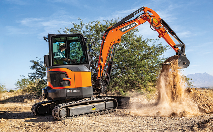 A DEVELON mini excavator working on a job site.