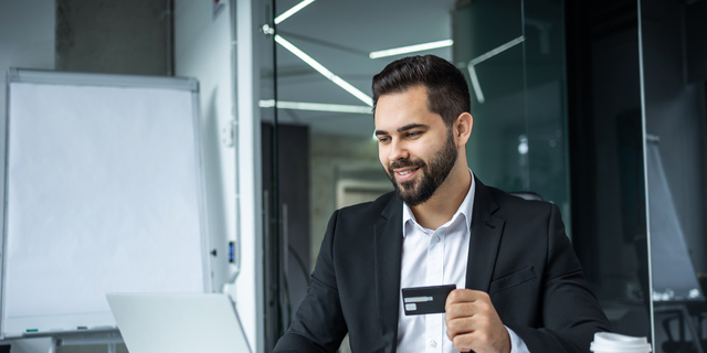 Happy man, business credit card and laptop for ecommerce, finance and accounting in office. Manager, computer and financial payment of budget