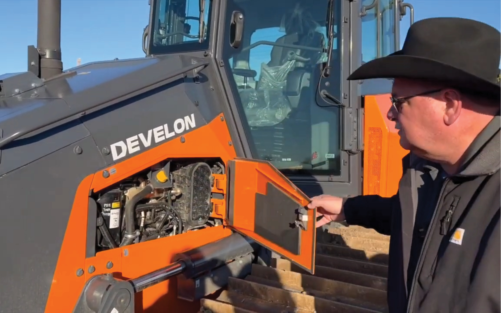 A DEVELON employee gives a walk-around of the DD130 dozer.