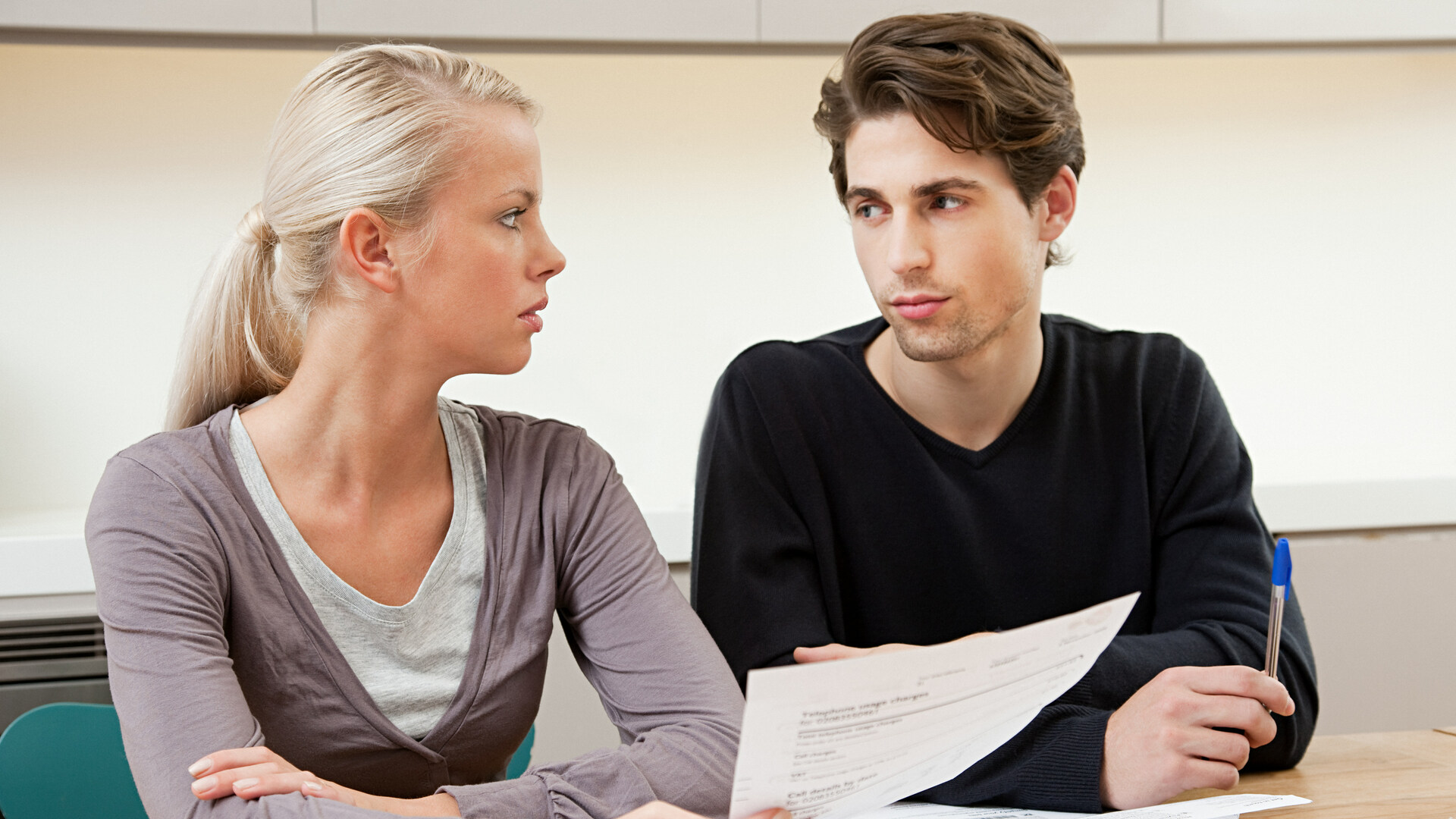 Serious young couple doing home finances