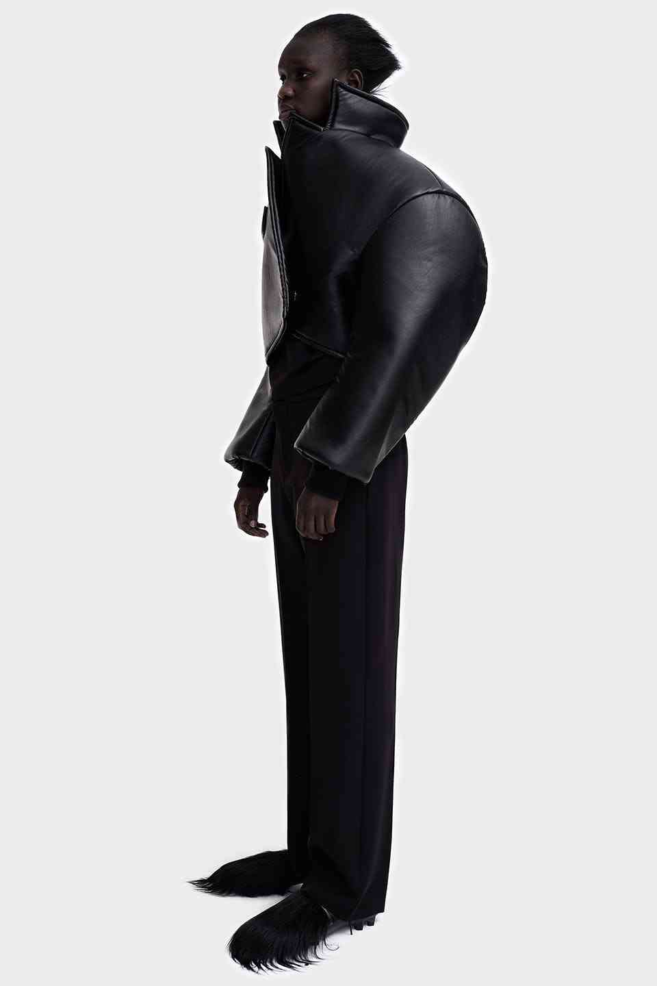 A model wearing a sculptural black jacket from MELITTA BAUMEISTER’s 2019–20 collection.