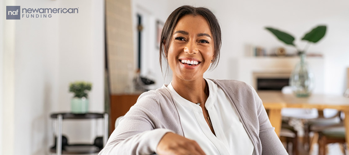 A Black woman smiles in her new home