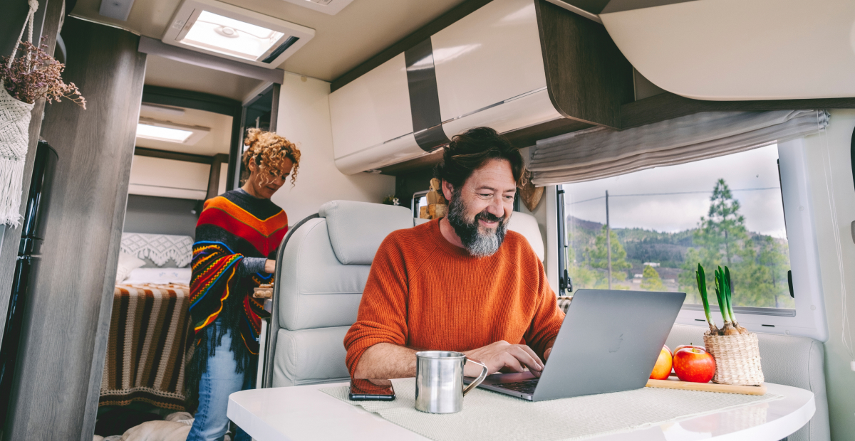 A man working on a laptop in his RV