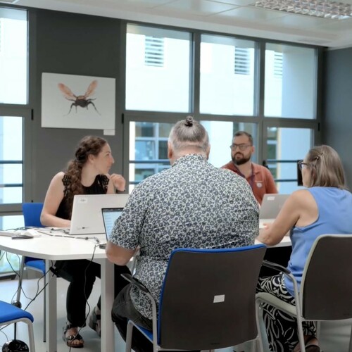 This image showcases the collaborative team effort between GE HealthCare and IB-Salut in digitising healthcare practices across the Balearic Islands. The diverse team of professionals is engaged in discussions, highlighting their commitment to improving patient care through innovative technology solutions.