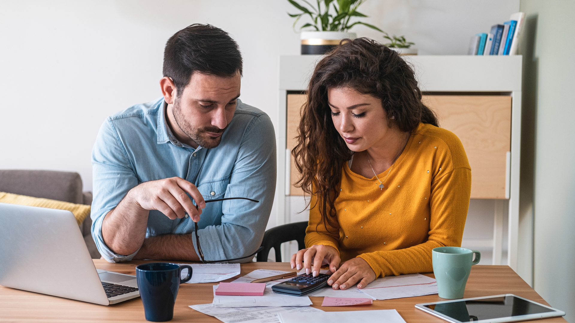 Young couple calculating their domestic bills at home stock photo