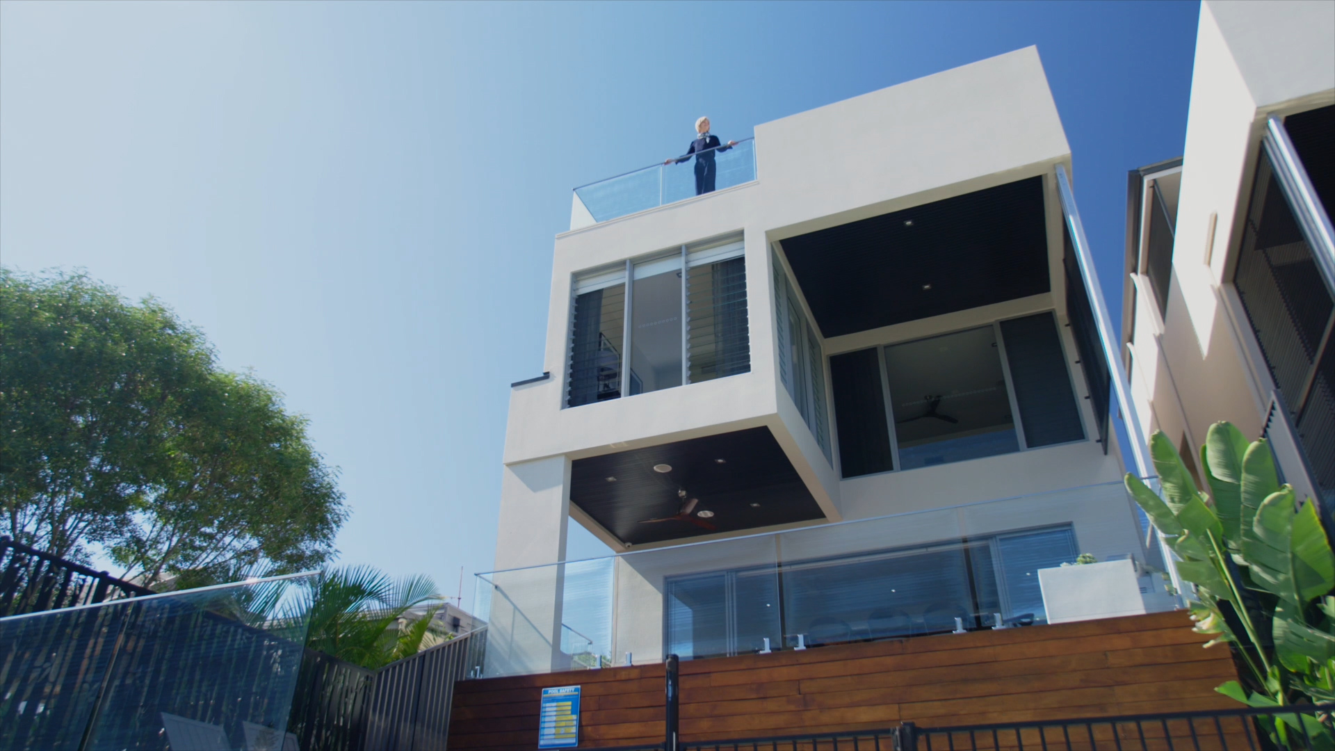 photo of a house with a pool next to a river