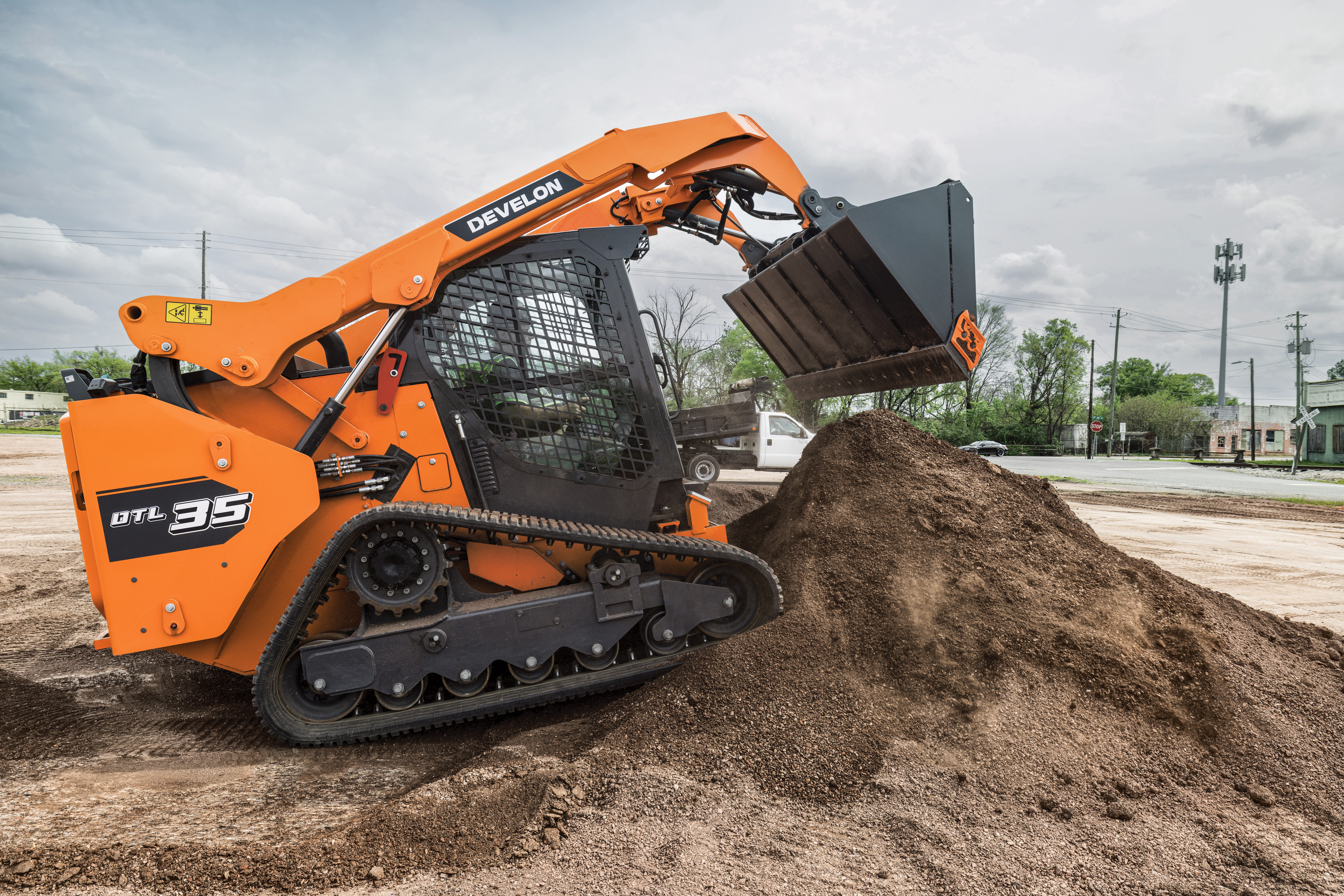 Introduces first compact track loader