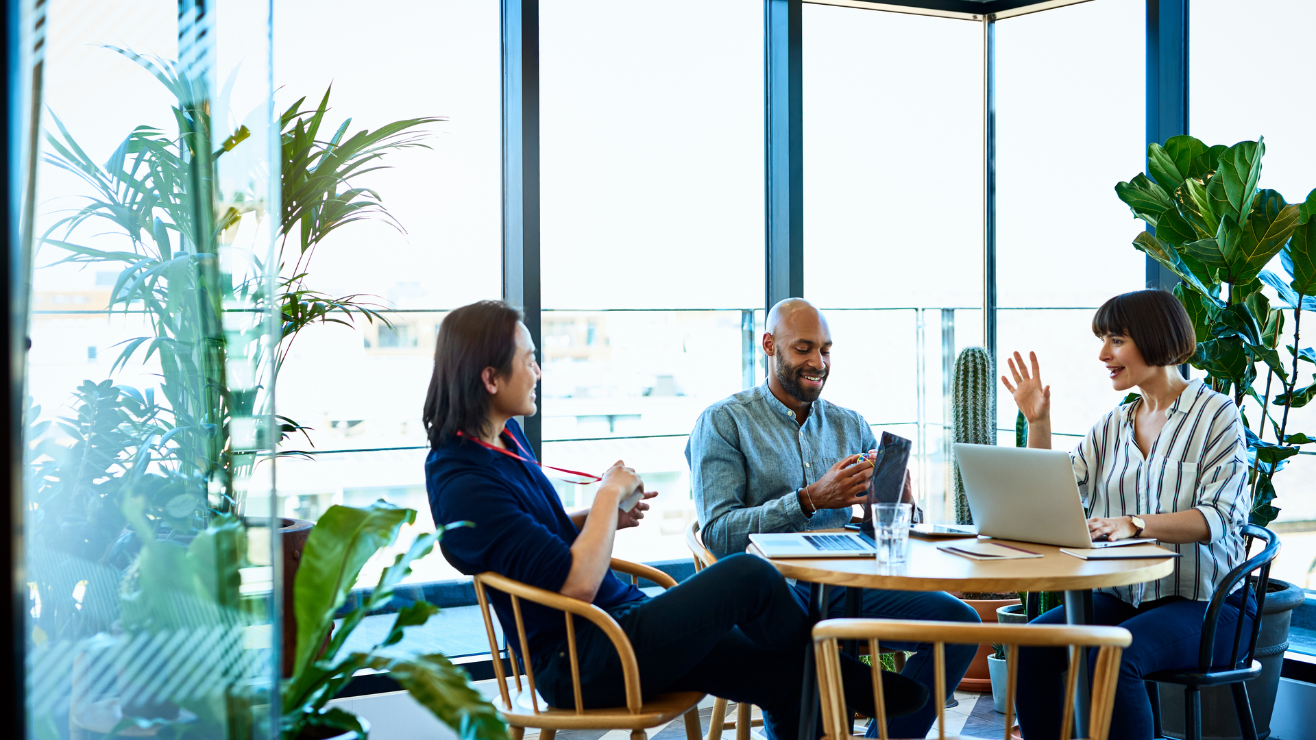 Three relaxed business colleagues meeting in cafe