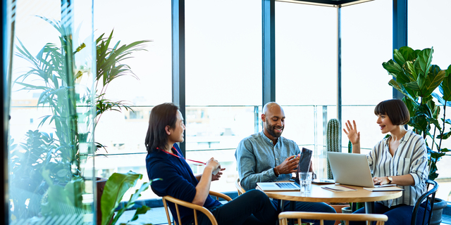 Three relaxed business colleagues meeting in cafe
