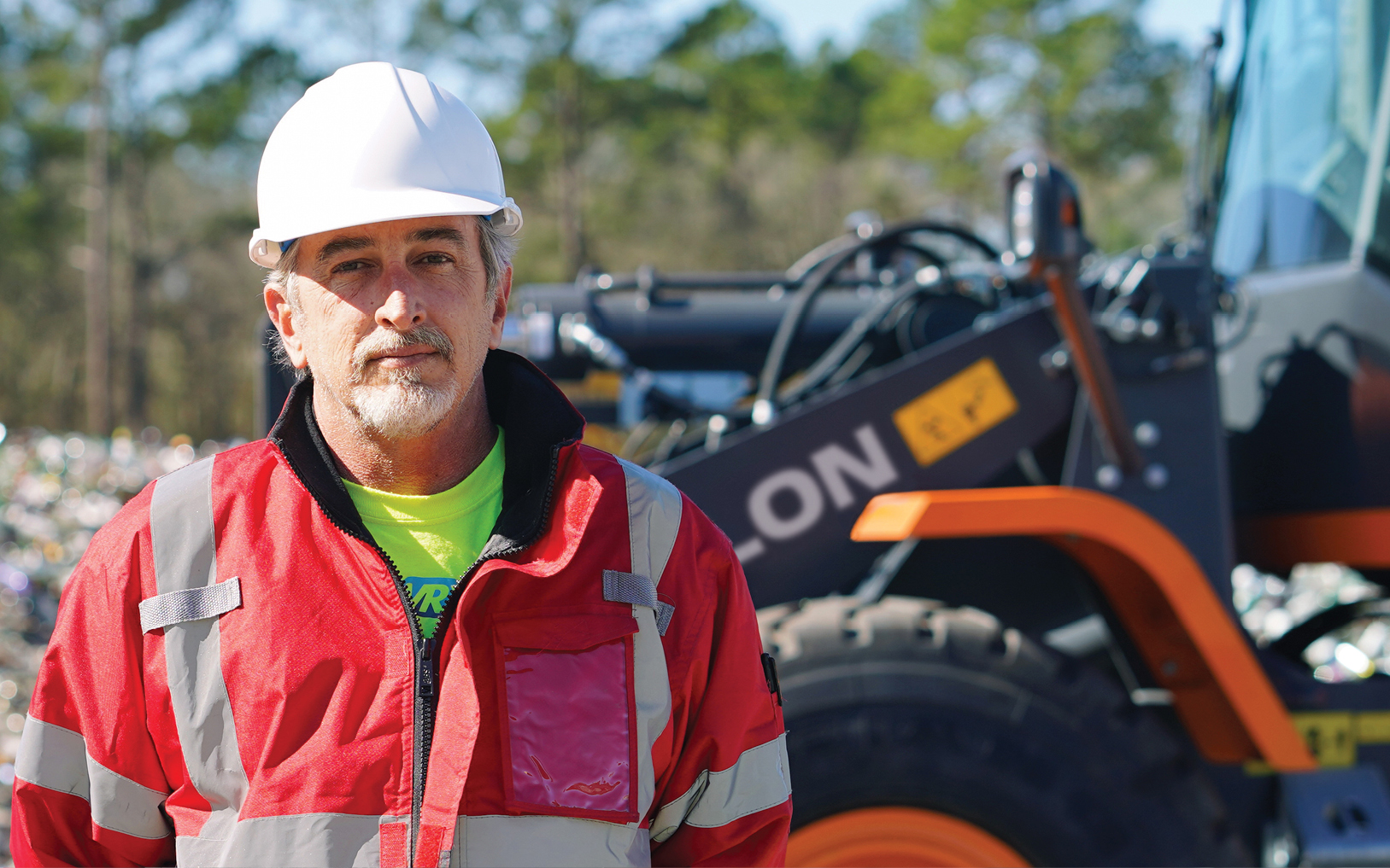 Brad Graham is the national director of site implementation at GlassWRX. He is pictured near a DEVELON wheel loader.