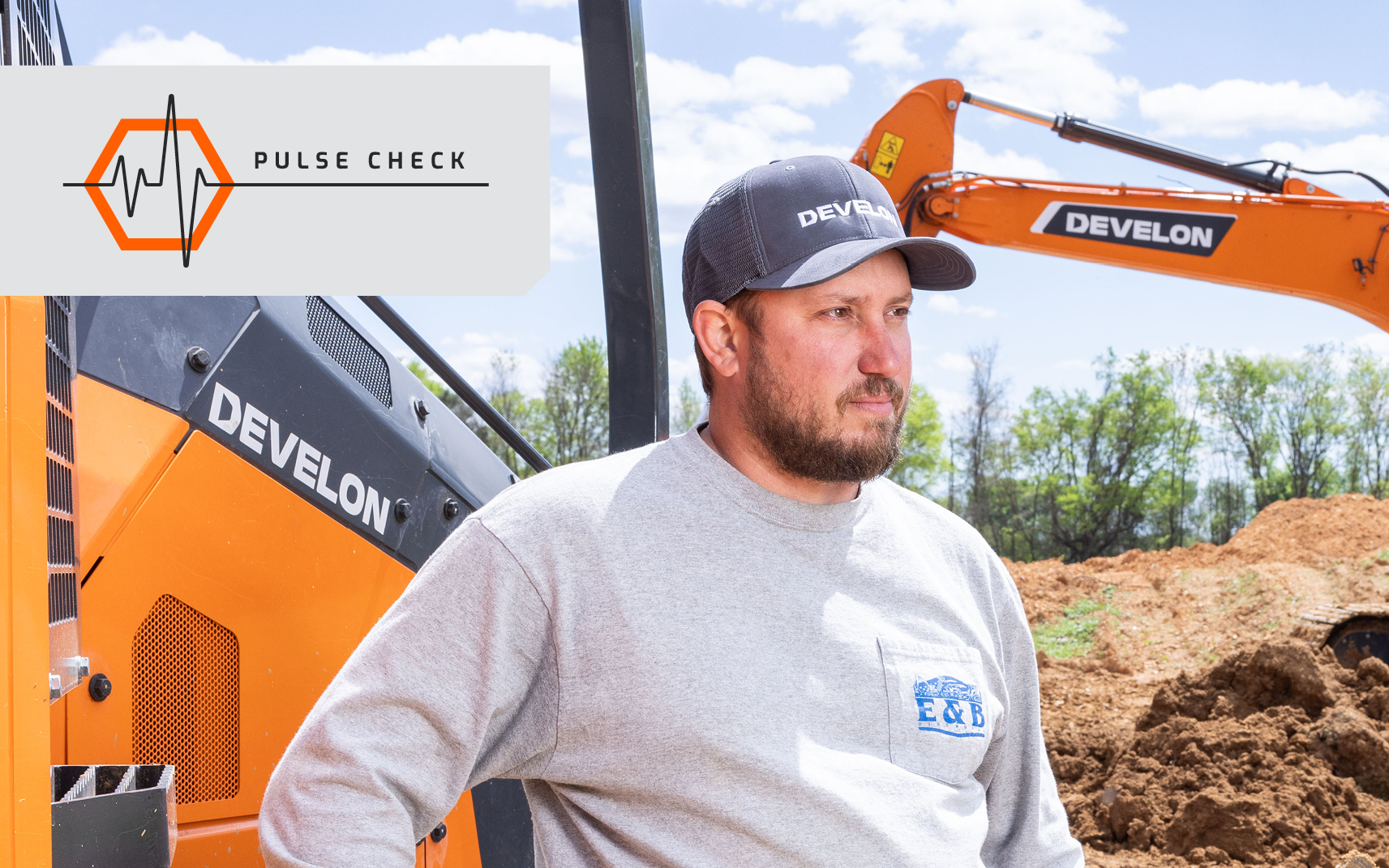 Eric Yarbrough of E & B Dirt Works is pictured next to a DEVELON dozer.