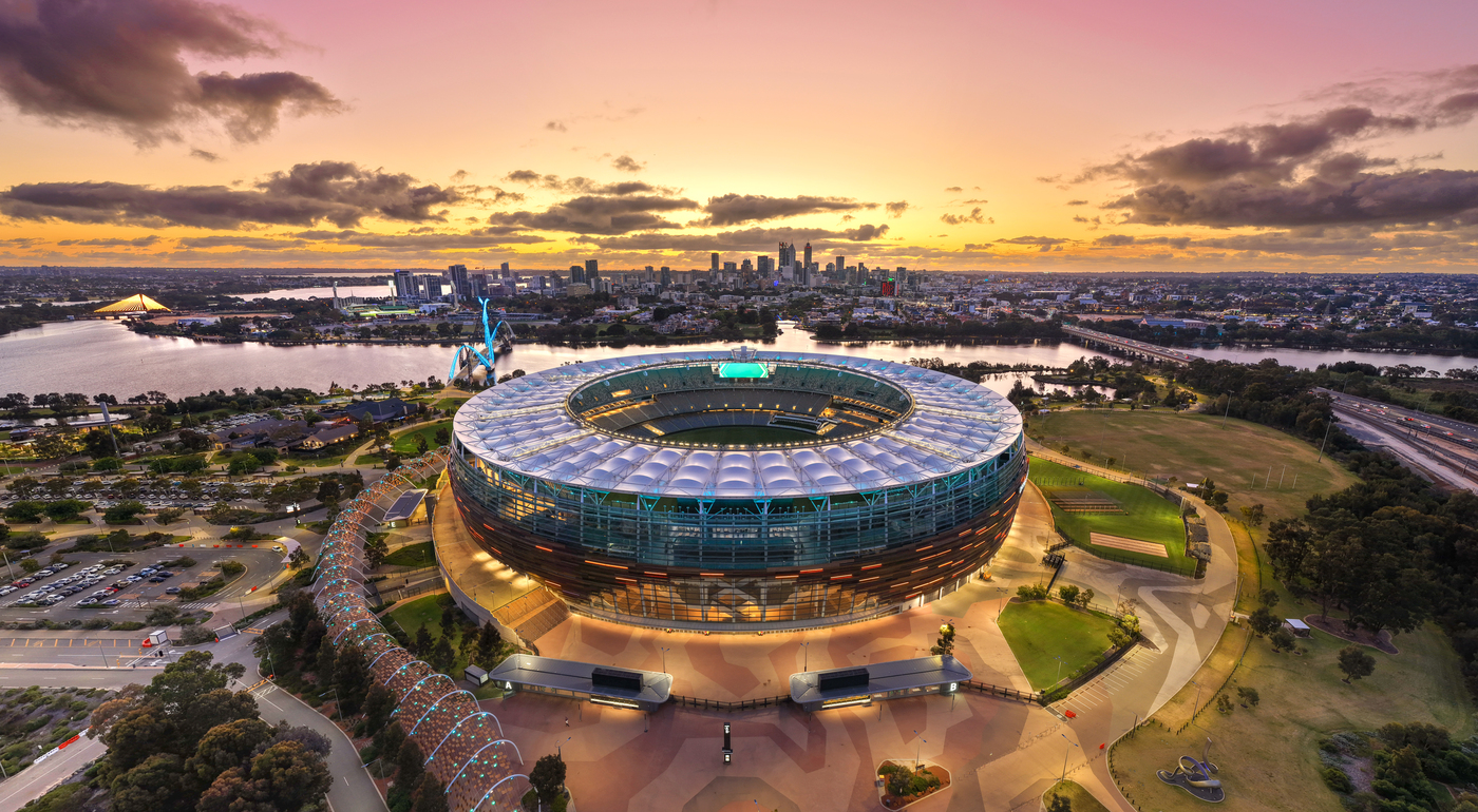 Aerial view of Optus Stadium looking towards the City of Perth at dusk