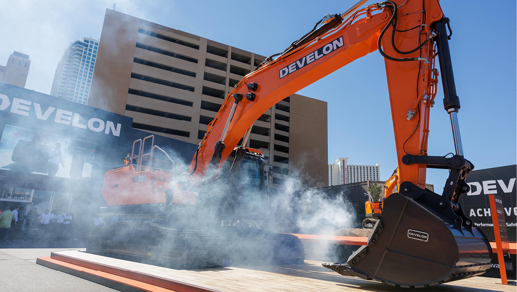 The reveal of the -9 Series DX400LC-9 at the DEVELON booth at CONEXPO 2026.
