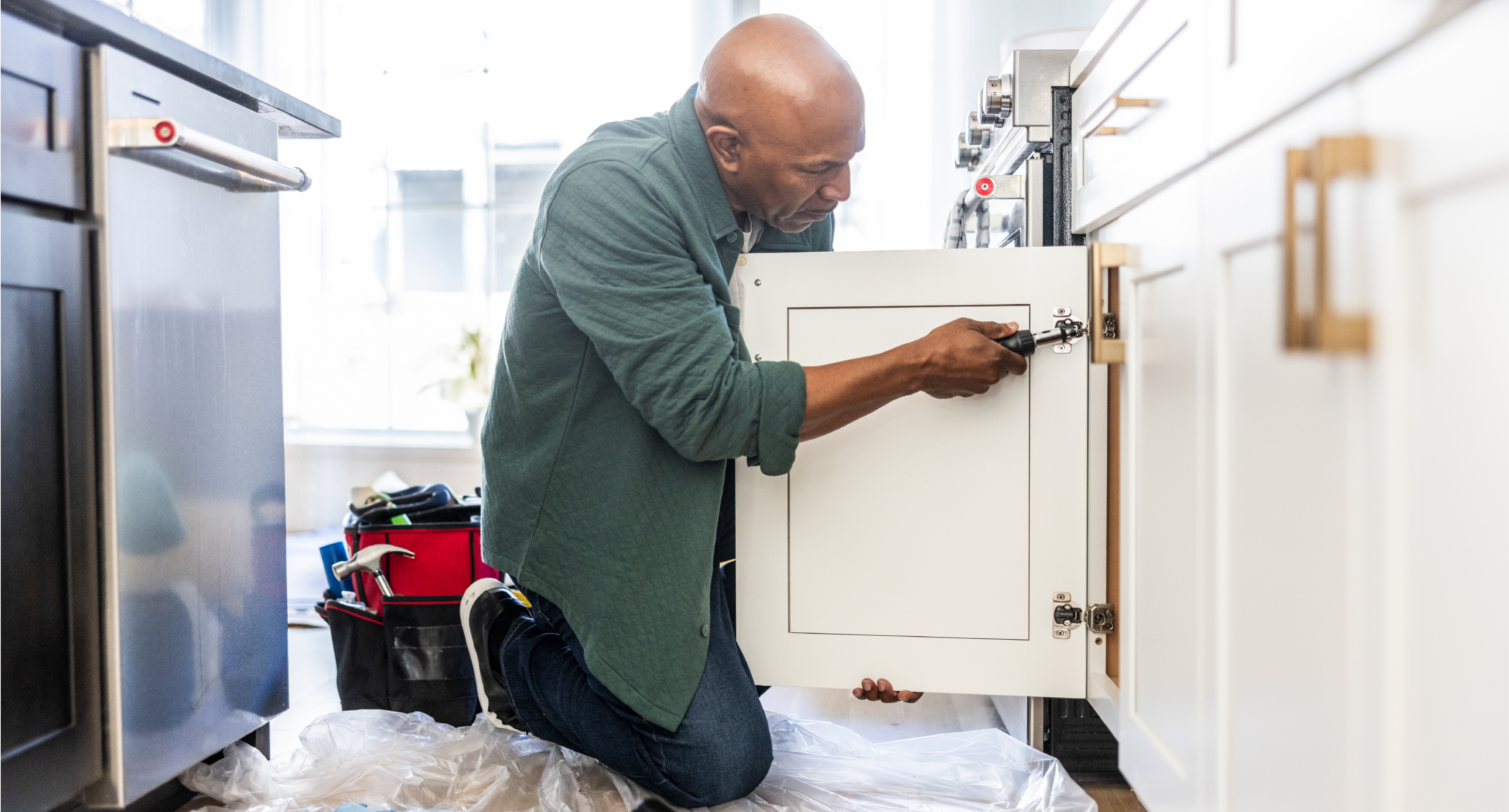 handyman repairing cabinet