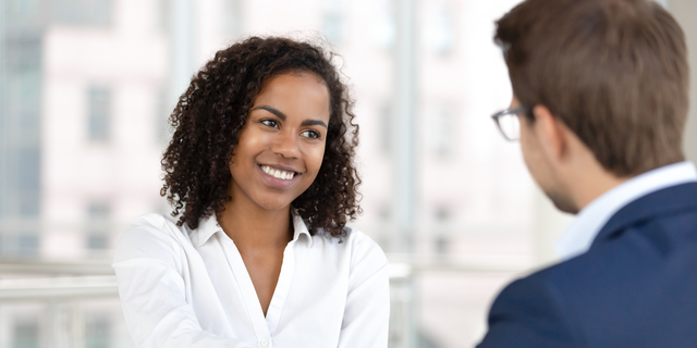 Smiling african hr manager handshake hire candidate at job interview