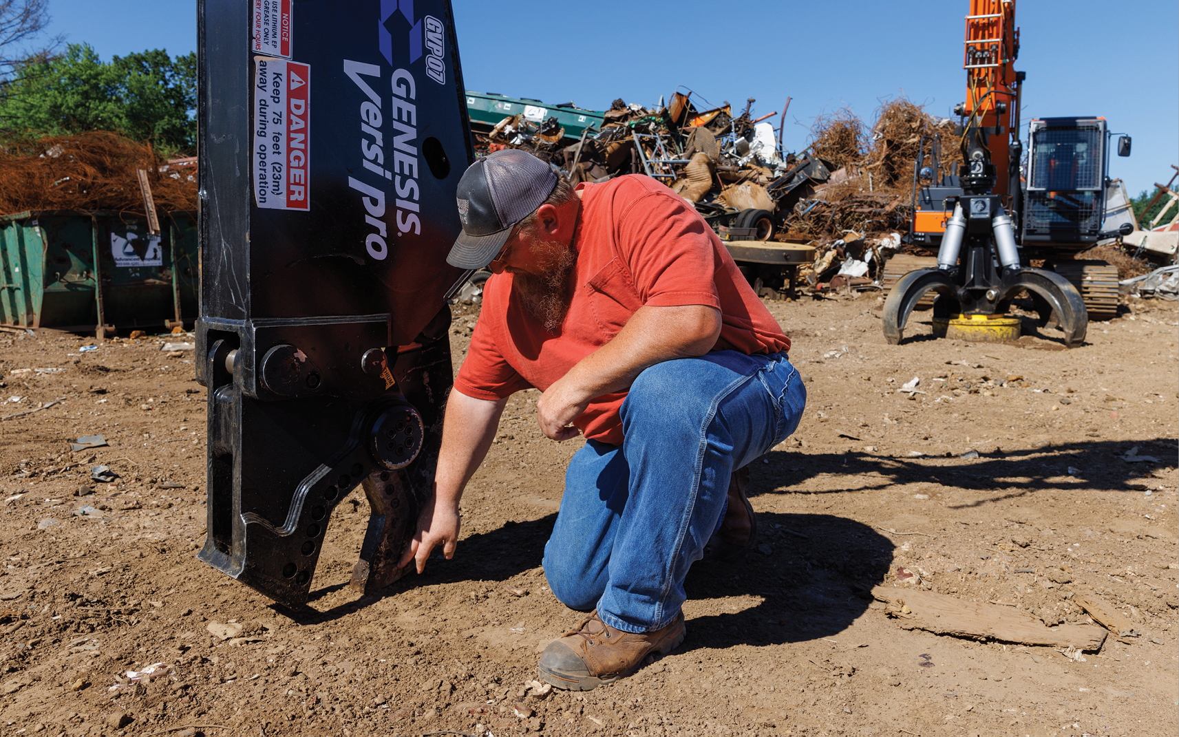 Chris Burt inspects the shear attachment for his DEVELON crawler excavator.