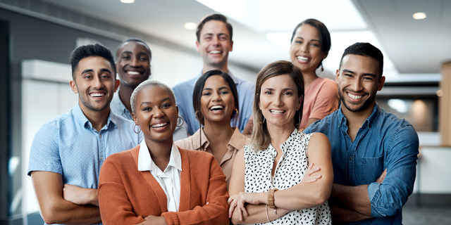 Portrait of a group of confident young businesspeople working together in a modern office