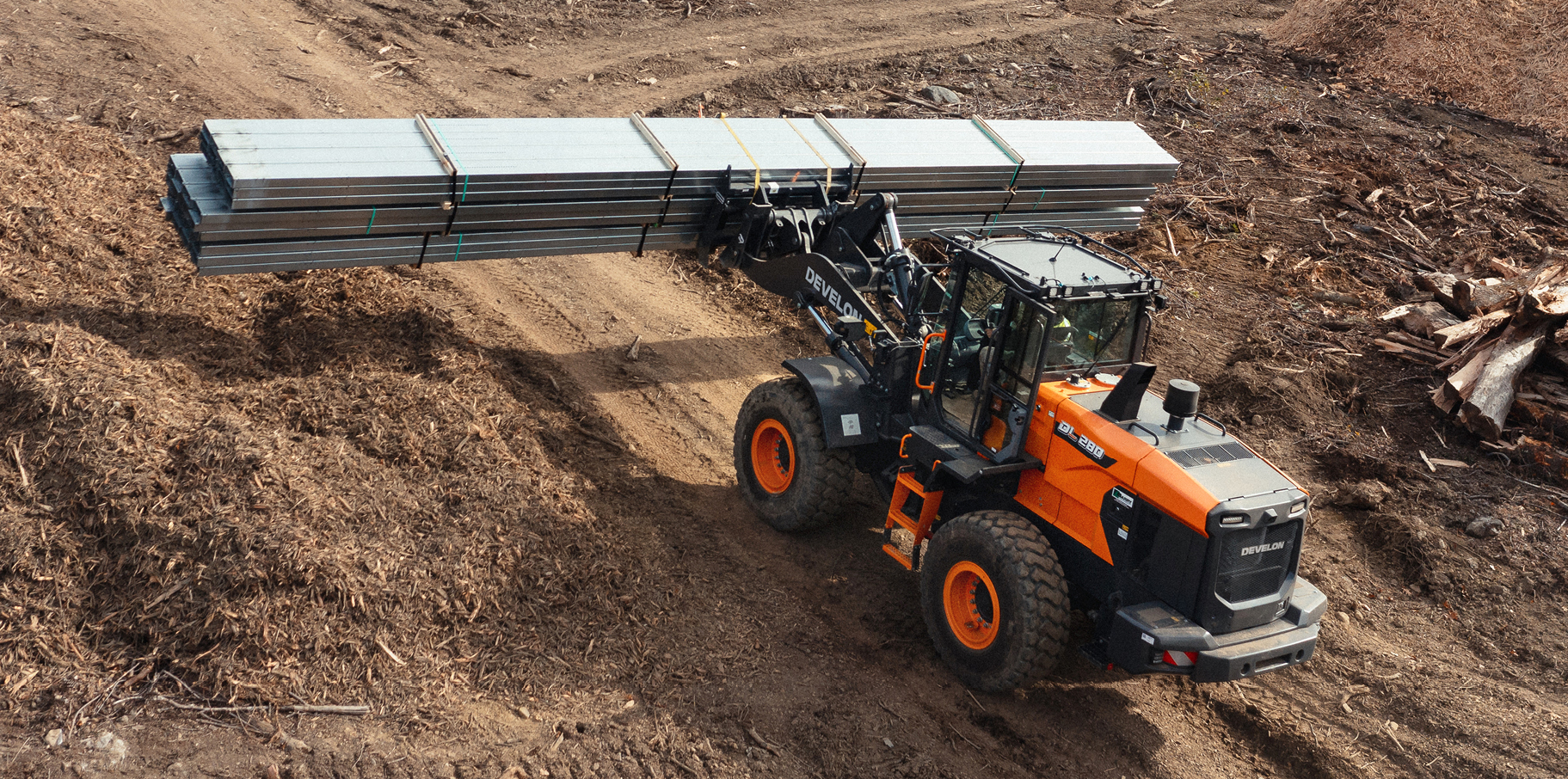 A DEVELON wheel loader hauls materials on a job site.