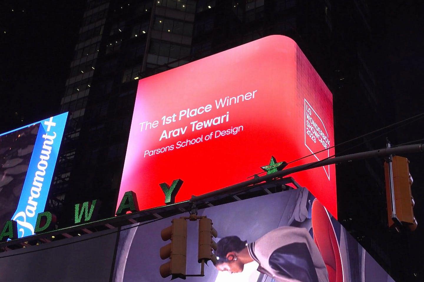 An animated billboard in Times Square that reads: “The 1st Place Winner Arav Tewari, Parsons School of Design.”