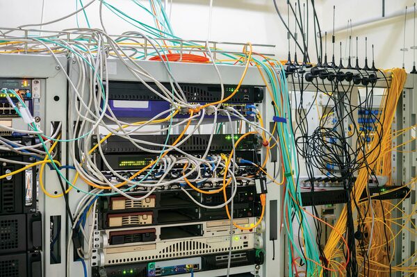 Example of poor cable management and messy server rack cabling before professional organization.