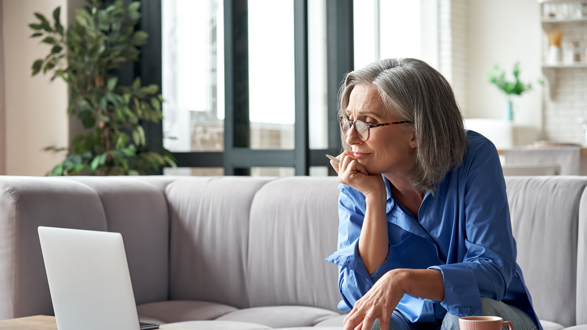 Senior mature older woman watching business training, online webinar on laptop computer remote working or social distance learning from home. 60s businesswoman video conference calling in virtual chat