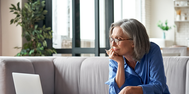 Senior mature older woman watching business training, online webinar on laptop computer remote working or social distance learning from home. 60s businesswoman video conference calling in virtual chat