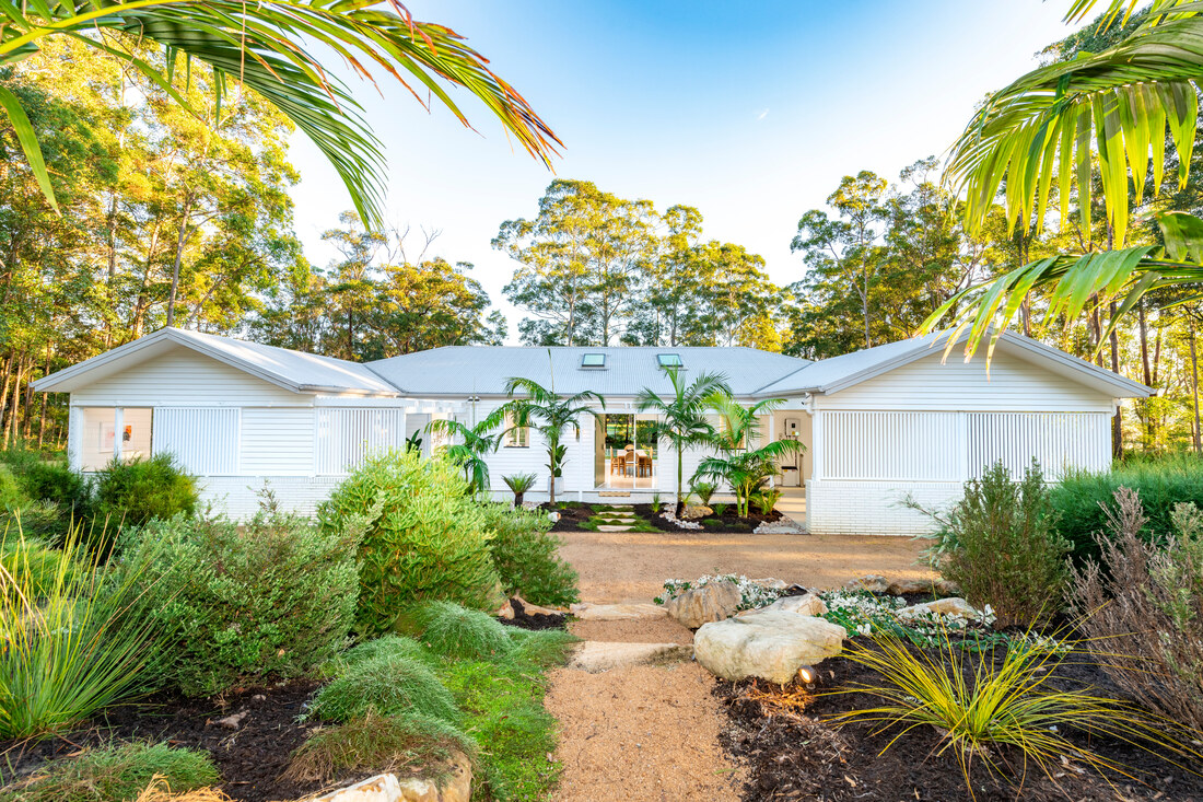 Draw 540 House Frontage. Single level home shown from the front surrounded by lush gardens.