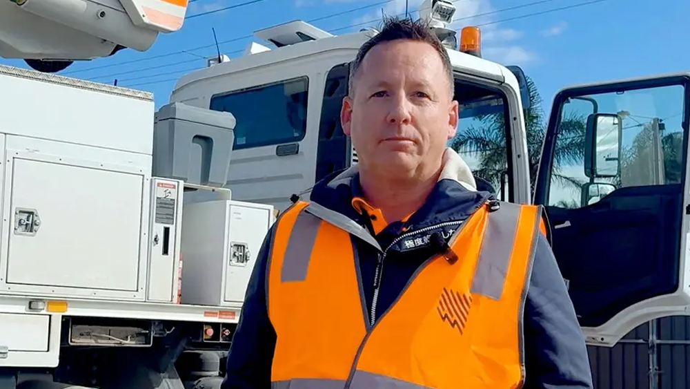 Picture of Mark Tate, SA Power Networks standing in front of a service truck