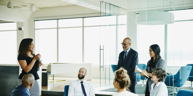 Businesswoman leading meeting with colleagues