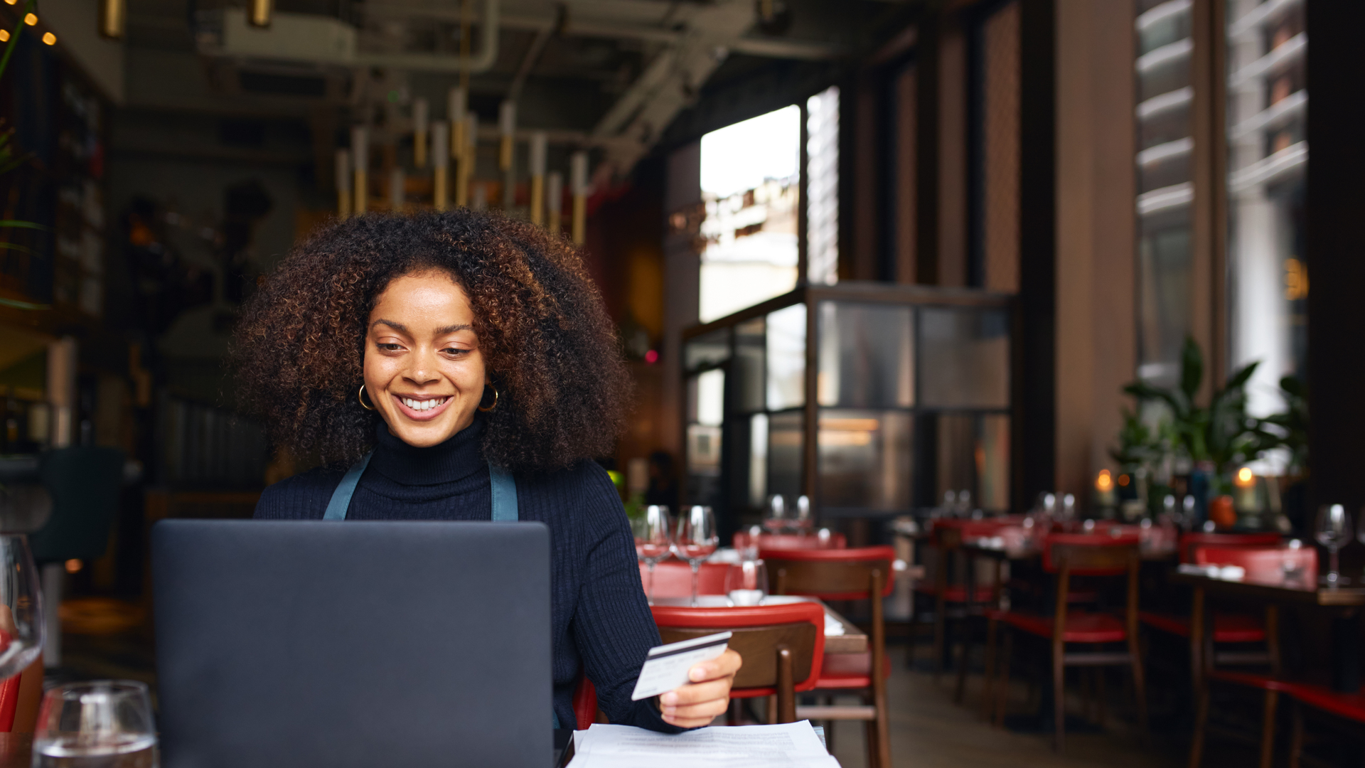 Portrait of restaurant owner using laptop