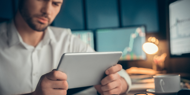 Man watching video or read the book at screen tablet