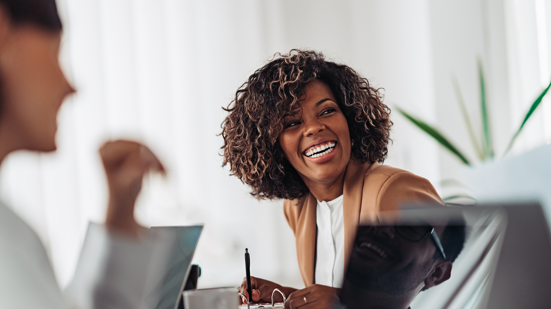 Portrait of cheerful businesswoman smiling at the meeting