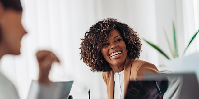 Portrait of cheerful businesswoman smiling at the meeting