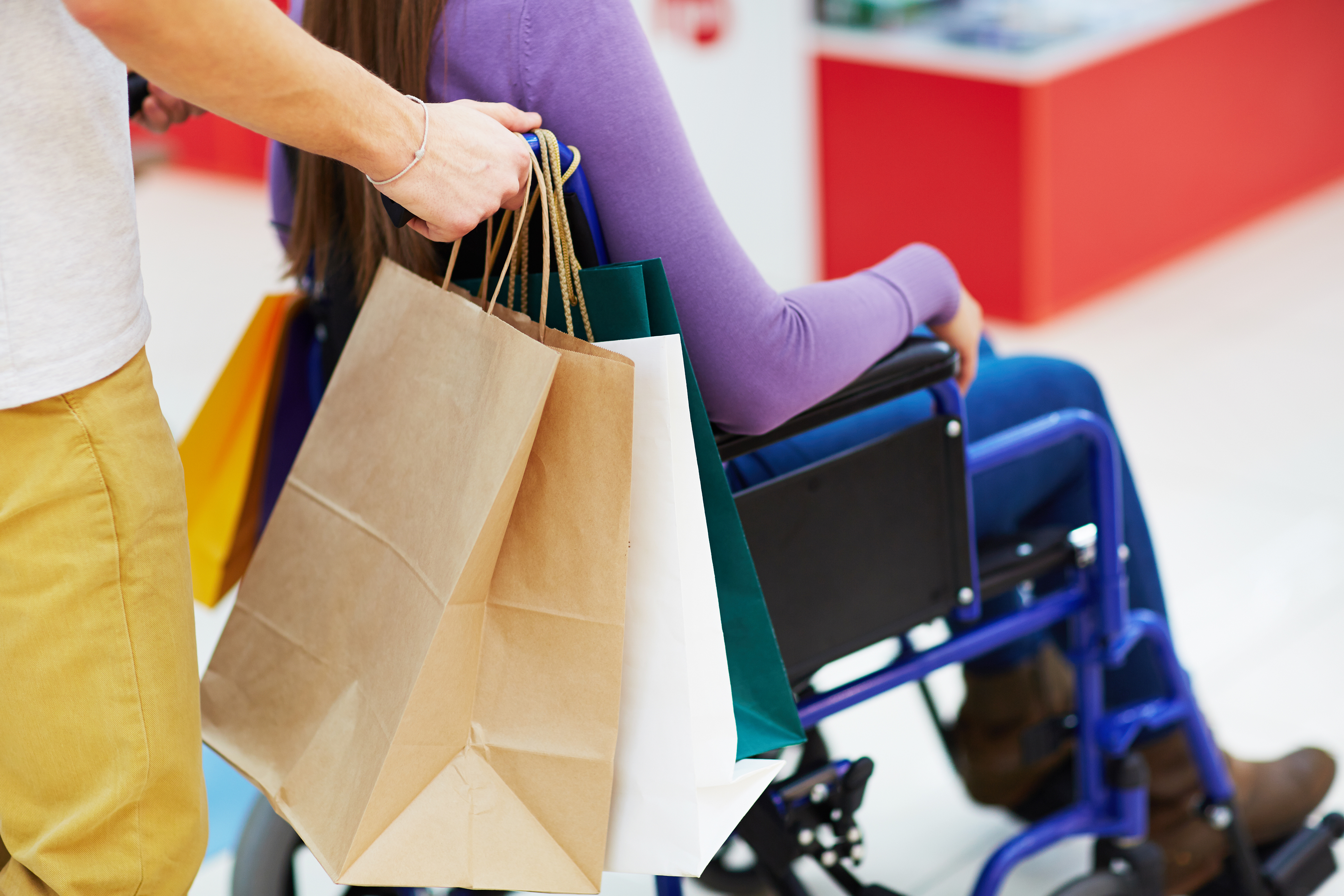 disabled customer taking help of assisted shopping in a retail store