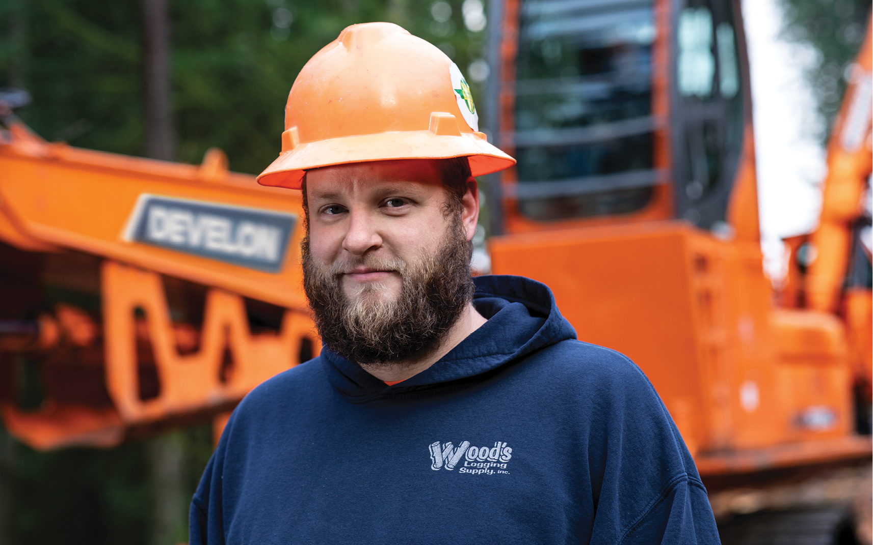 Shane Hiett standing in front of his DEVELON machine.