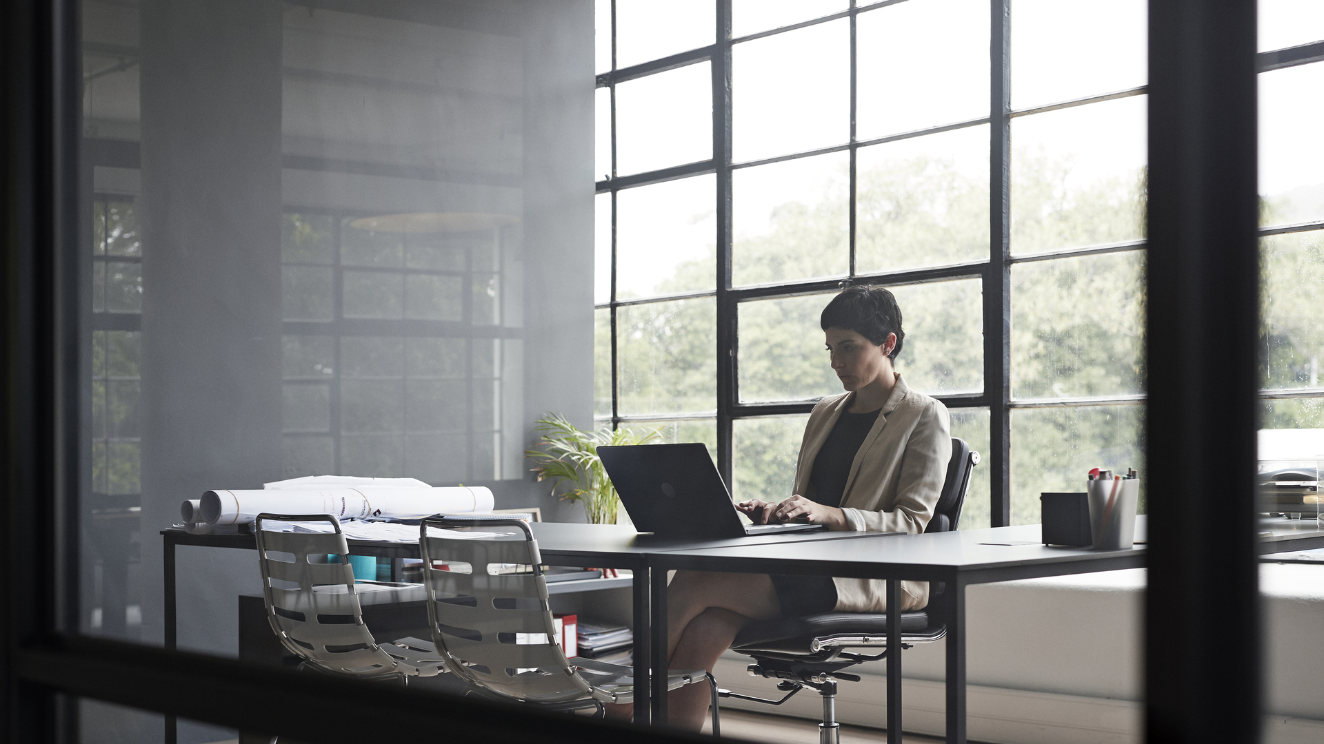 Entrepreneur typing over laptop in modern office