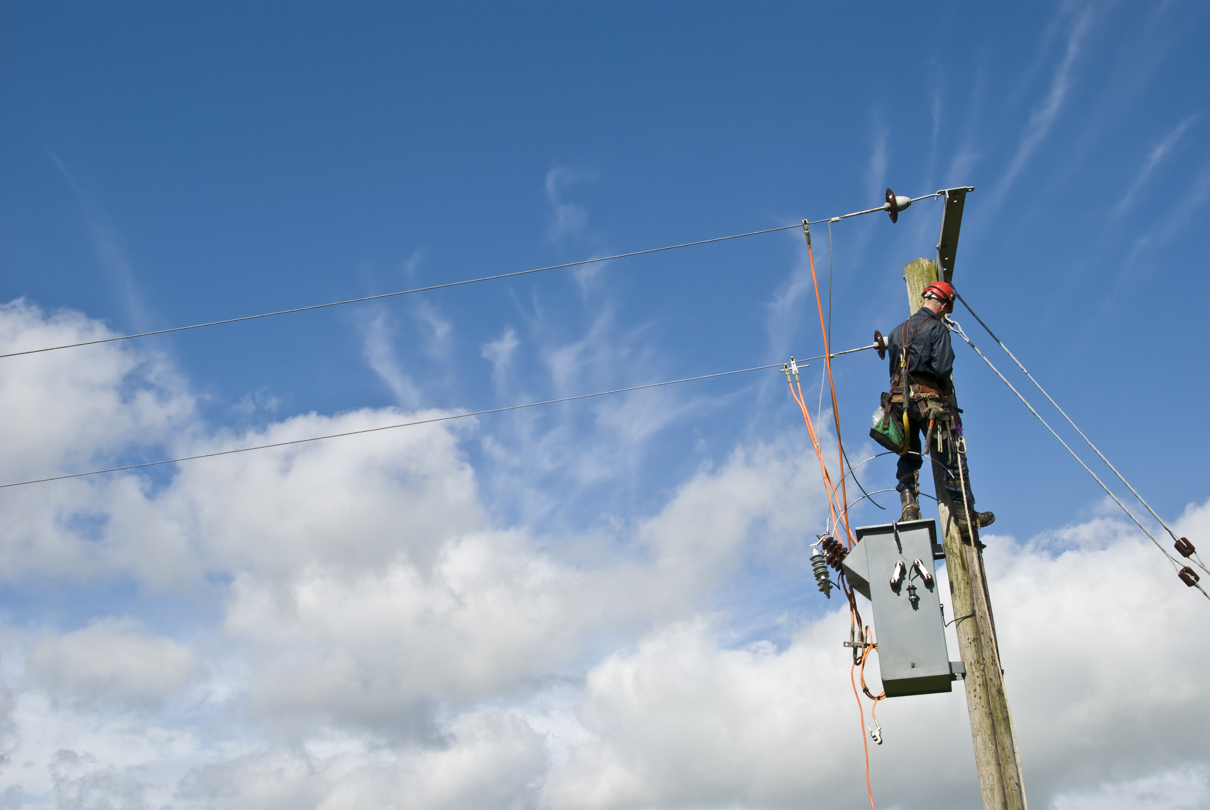 A field service technician working on power lines.