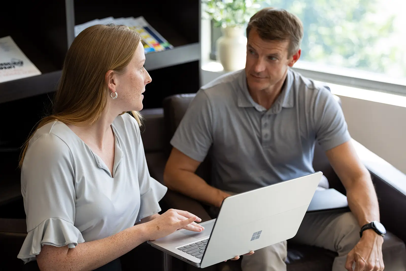 Services industry colleagues exchanging ideas and working side by side in a business setting