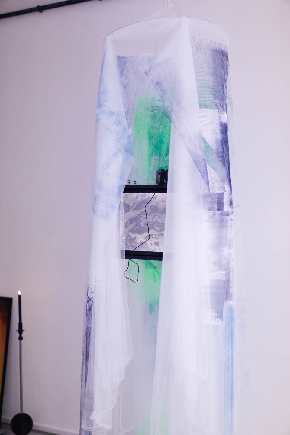 Hanging translucent fabric installation with soft light and colors