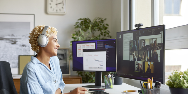 Happy Businesswoman on Video Call With Colleagues