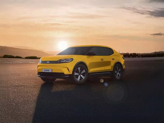 Yellow Ford Capri in front of a sunset