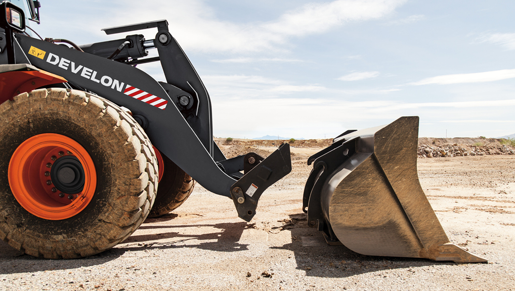 A DEVELON wheel loader arm preparing to attach a bucket.